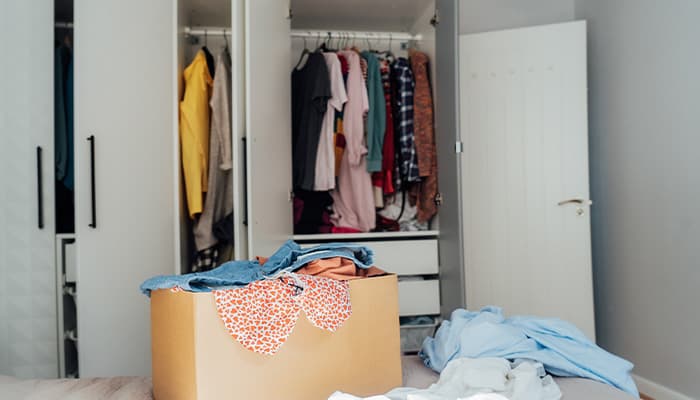 Cardboard box full of clothes