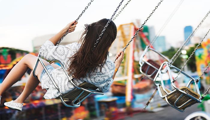 woman riding a swing fairground ride