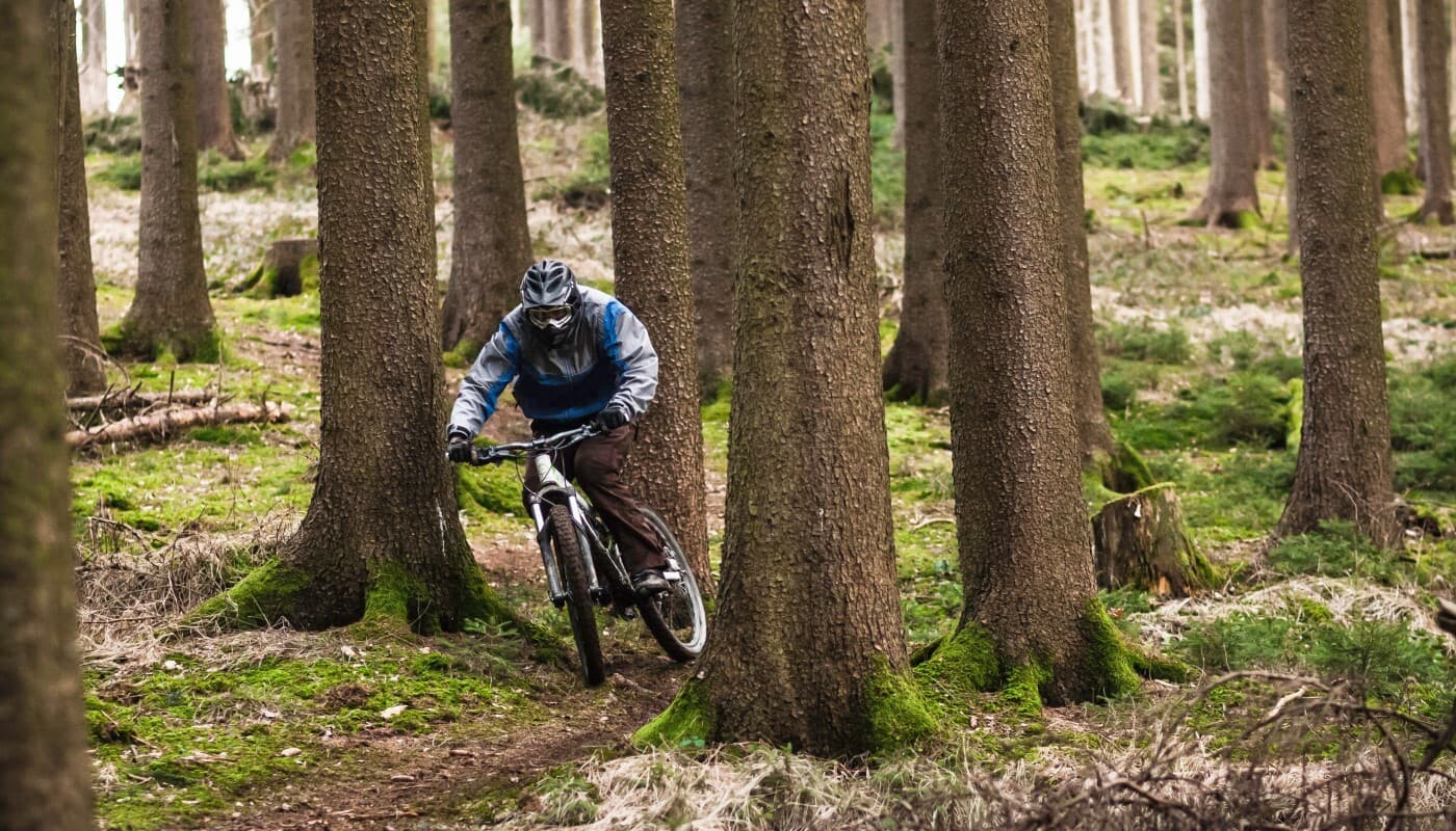 Man riding mountain bike down hill